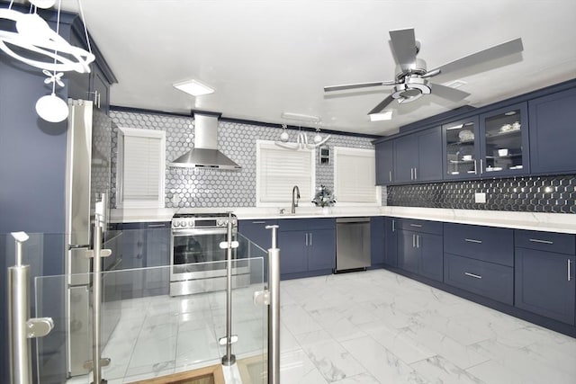 541 Grattan St, Chicopee, MA 01020 - kitchen featuring appliances with stainless steel finishes, wall chimney exhaust hood, blue cabinetry, and backsplash