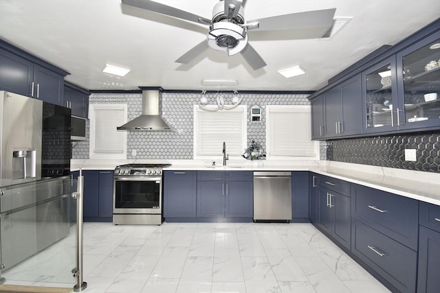 541 Grattan St, Chicopee, MA 01020 - kitchen with appliances with stainless steel finishes, wall chimney exhaust hood, light marble finish flooring, ceiling fan, and light countertops