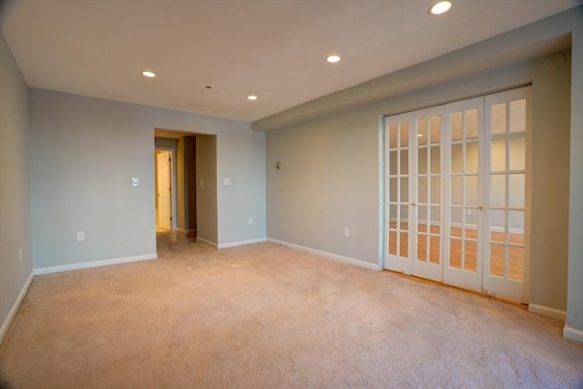 unfurnished room featuring recessed lighting, light colored carpet, and baseboards