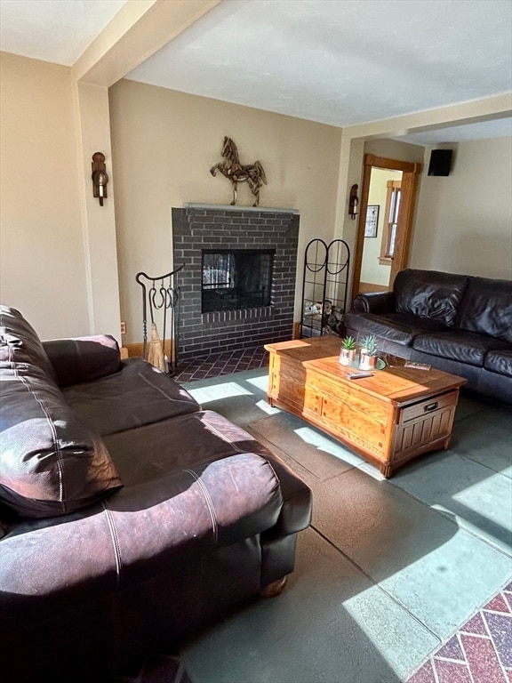 living room with a fireplace and carpet