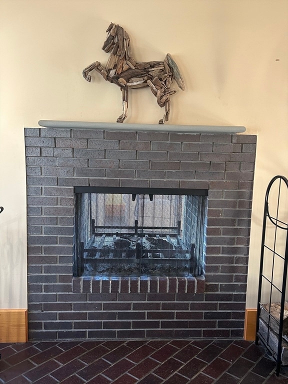 interior details featuring a brick fireplace