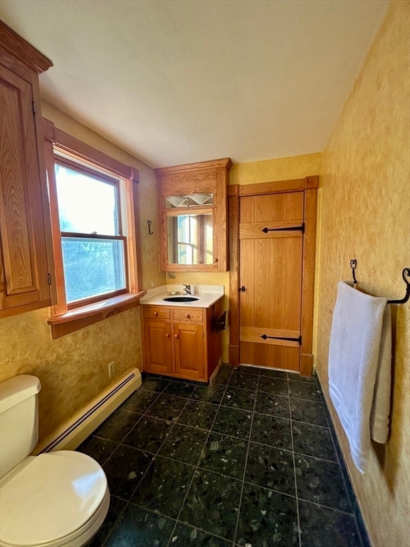 bathroom featuring vanity, toilet, and a baseboard radiator