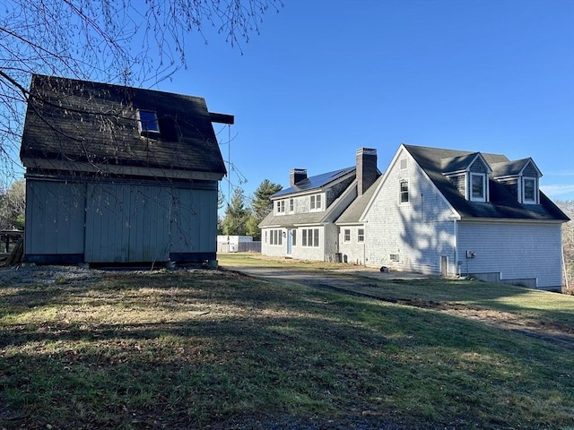 view of property exterior featuring a lawn