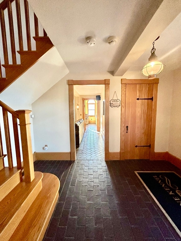 hallway with lofted ceiling and a textured ceiling