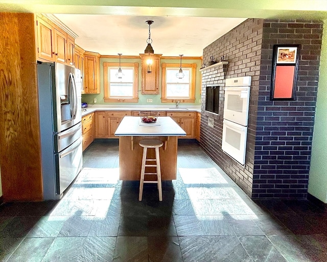 kitchen with stainless steel refrigerator with ice dispenser, a kitchen island, and brick wall