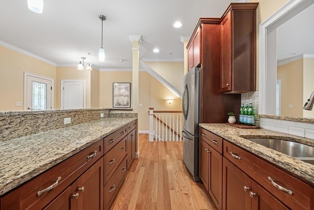 960 Main St Unit C, Woburn, MA 01801 - kitchen featuring freestanding refrigerator, a sink, light wood finished floors, light stone countertops, and crown molding