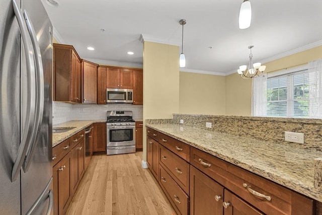 960 Main St Unit C, Woburn, MA 01801 - kitchen featuring stainless steel appliances, crown molding, light wood-type flooring, backsplash, and light stone counters