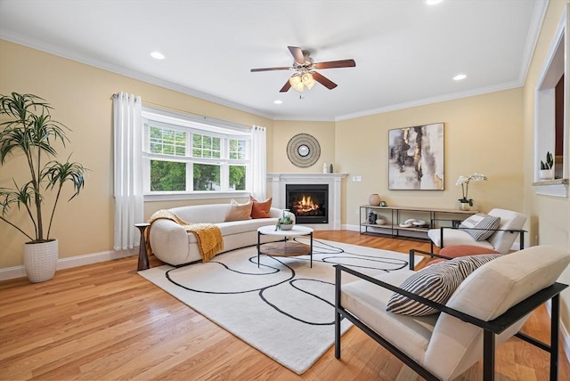 960 Main St Unit C, Woburn, MA 01801 - living area with a ceiling fan, light wood-type flooring, a warm lit fireplace, baseboards, and ornamental molding