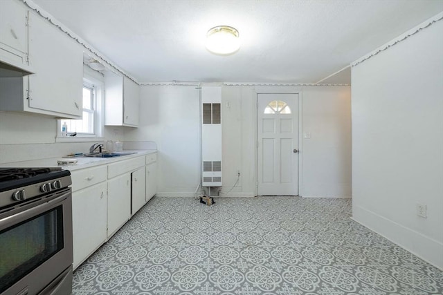 224-232 Caroline, New Bedford, MA 02740 - kitchen with a heating unit, a sink, gas range, light countertops, and white cabinets
