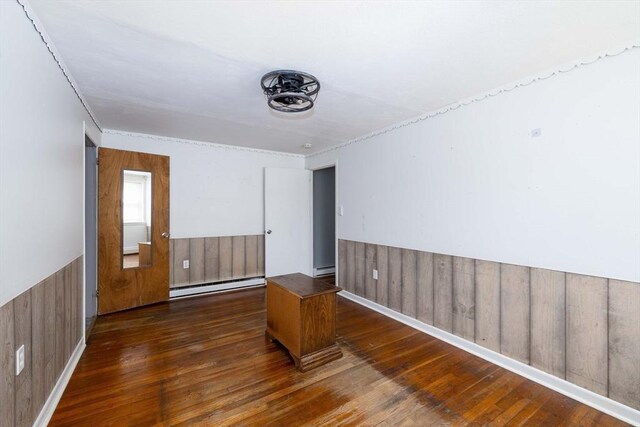 224-232 Caroline, New Bedford, MA 02740 - spare room with baseboard heating, wood-type flooring, wainscoting, wood walls, and a baseboard radiator