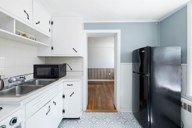 224-232 Caroline, New Bedford, MA 02740 - kitchen with black appliances, radiator, light countertops, white cabinetry, and wainscoting