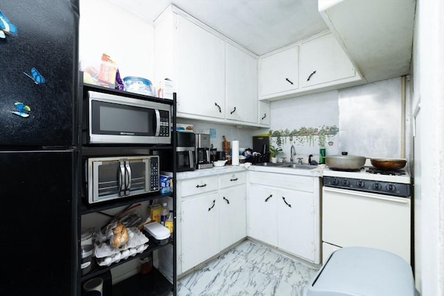 224-232 Caroline, New Bedford, MA 02740 - kitchen featuring stainless steel microwave, freestanding refrigerator, gas range gas stove, a sink, and light marble finish floors