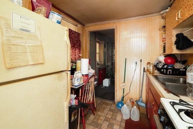 224-232 Caroline, New Bedford, MA 02740 - kitchen with freestanding refrigerator, gas stove, brick patterned flooring, and wooden walls