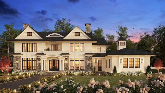 65 Temple Rd, Wellesley, MA 02482 - view of front facade featuring french doors, a chimney, stone siding, and a yard