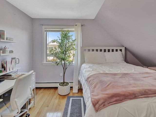 10 Vernon Ave, Hull, MA 02045 - bedroom with wood finished floors, baseboard heating, vaulted ceiling, and a desk