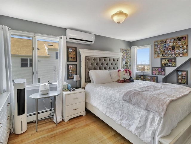 10 Vernon Ave, Hull, MA 02045 - bedroom with baseboard heating, an AC wall unit, and light wood-style flooring