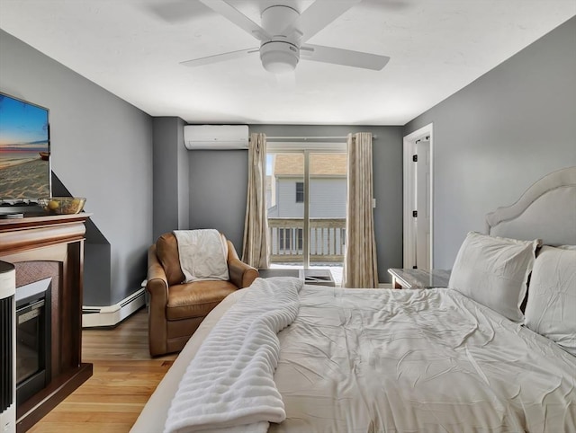 10 Vernon Ave, Hull, MA 02045 - bedroom with a wall mounted AC, a baseboard heating unit, wood finished floors, access to outside, and a ceiling fan