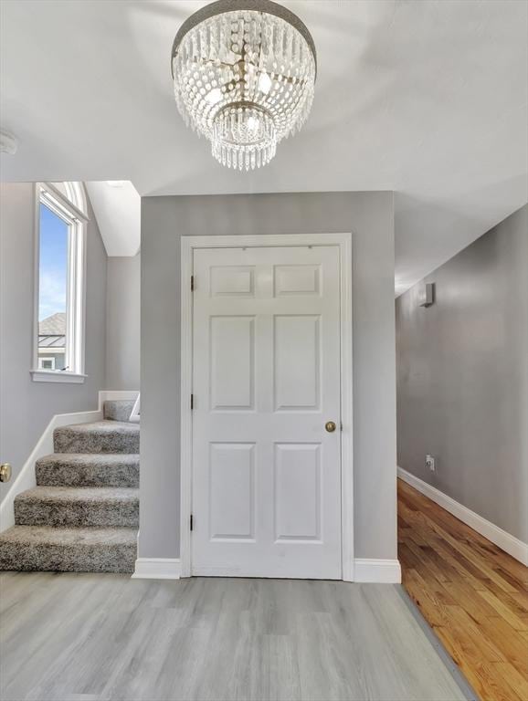10 Vernon Ave, Hull, MA 02045 - stairway with wood finished floors and a chandelier