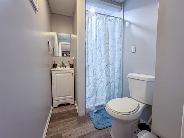 bathroom featuring walk in shower, hardwood / wood-style floors, vanity, and toilet