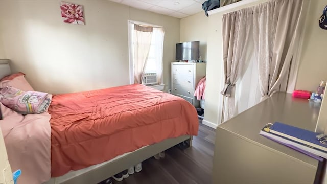 bedroom with dark hardwood / wood-style floors, a drop ceiling, and cooling unit