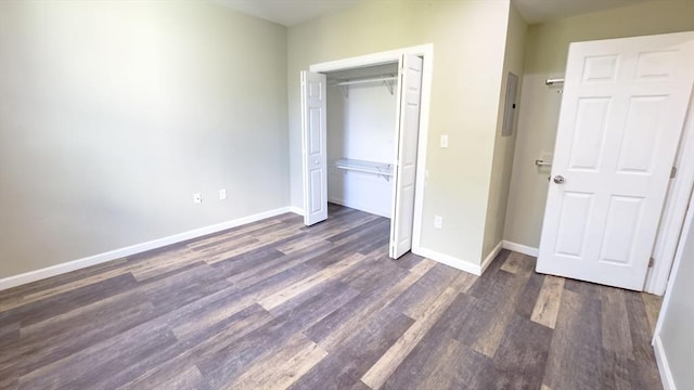 unfurnished bedroom featuring dark hardwood / wood-style floors and a closet