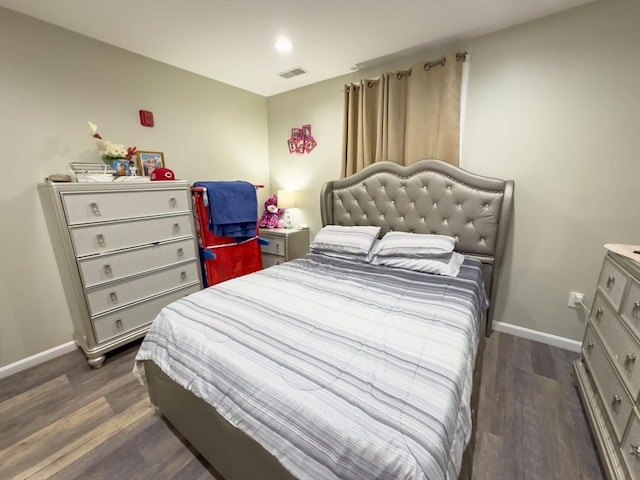 bedroom with dark hardwood / wood-style flooring