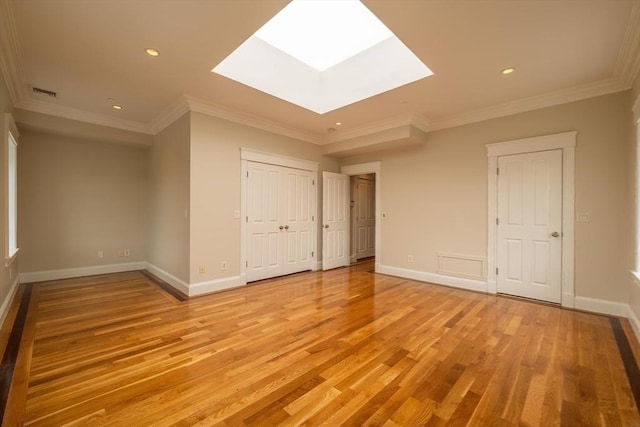 bonus room featuring a skylight, baseboards, visible vents, and light wood finished floors