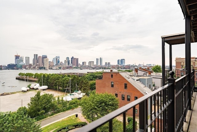 balcony with a view of city and a water view