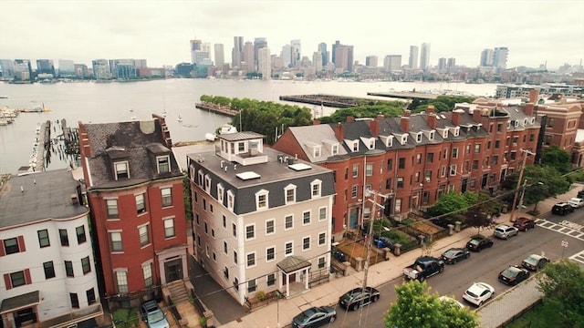 drone / aerial view featuring a view of city and a water view