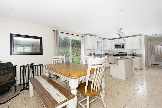 54 Clarke Rd, Sturbridge, MA 01518 - dining space featuring light tile patterned floors and a wood stove