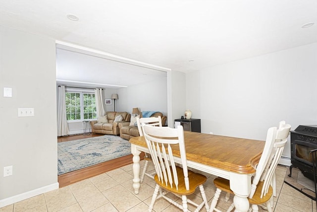 54 Clarke Rd, Sturbridge, MA 01518 - dining area featuring a wood stove and light tile patterned floors