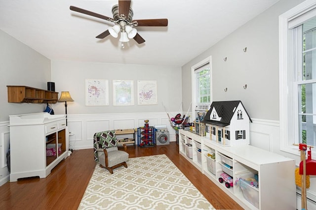 54 Clarke Rd, Sturbridge, MA 01518 - game room with wood finished floors, ceiling fan, wainscoting, a decorative wall, and a baseboard radiator