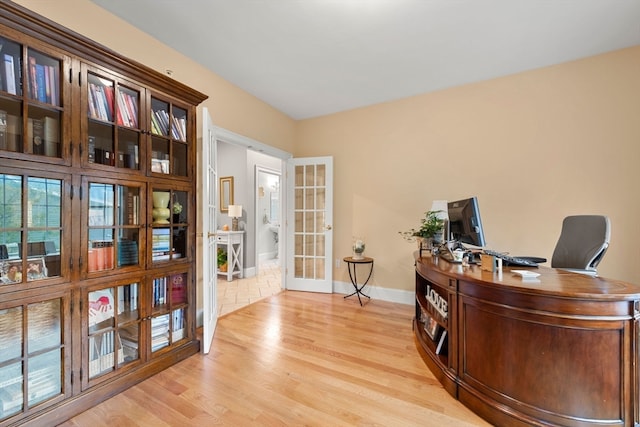 office area featuring french doors and light hardwood / wood-style flooring