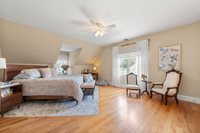 bedroom with ceiling fan, light hardwood / wood-style flooring, and lofted ceiling