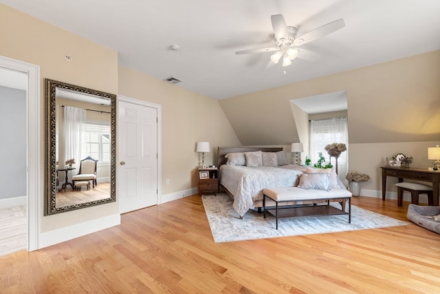 bedroom featuring ceiling fan, light hardwood / wood-style floors, and vaulted ceiling