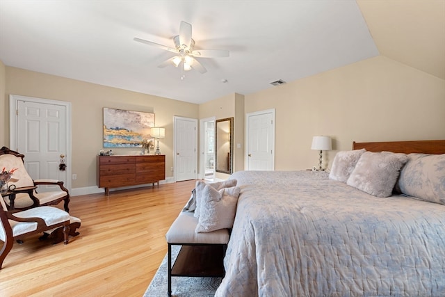 bedroom with ceiling fan, wood-type flooring, and vaulted ceiling