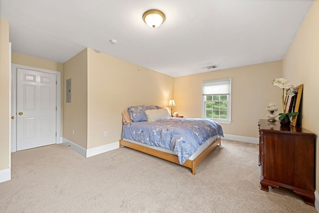 bedroom featuring light carpet and electric panel