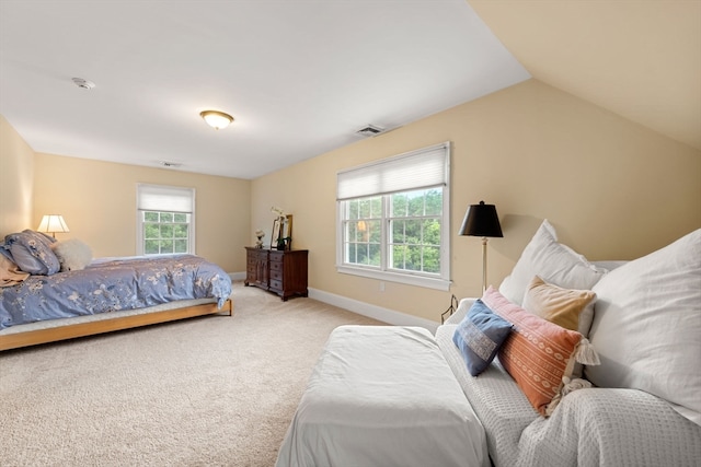 carpeted bedroom featuring lofted ceiling