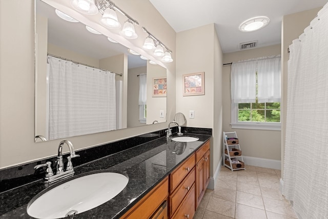 bathroom with tile patterned floors and vanity