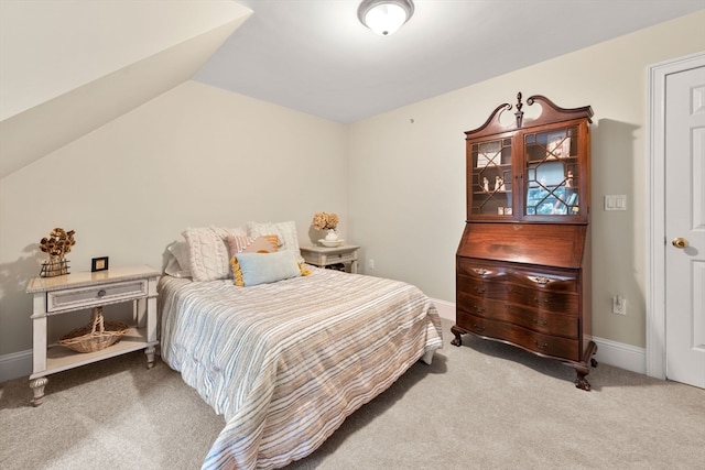 carpeted bedroom featuring vaulted ceiling