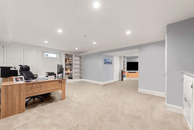 office with light carpet and built in shelves