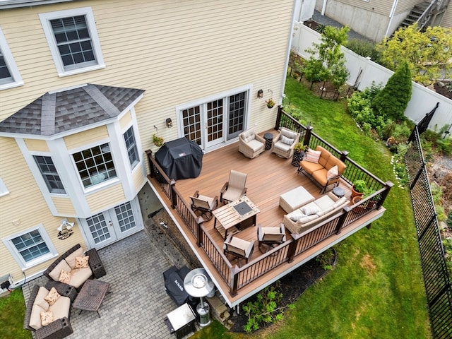 exterior space featuring outdoor lounge area, a wooden deck, and french doors