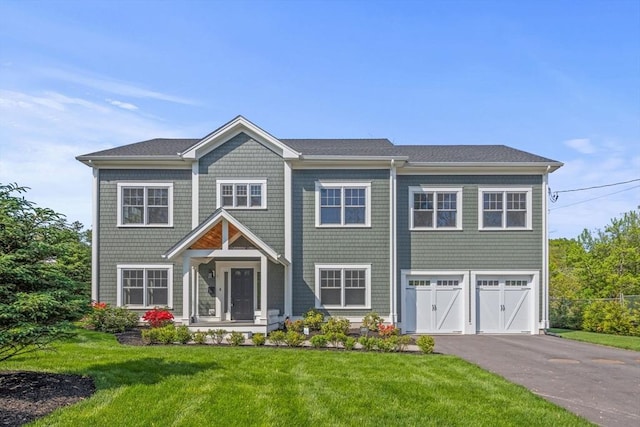 1 Farwell Cir, Newton, MA 02460 - view of front of property with asphalt driveway, an attached garage, and a front lawn