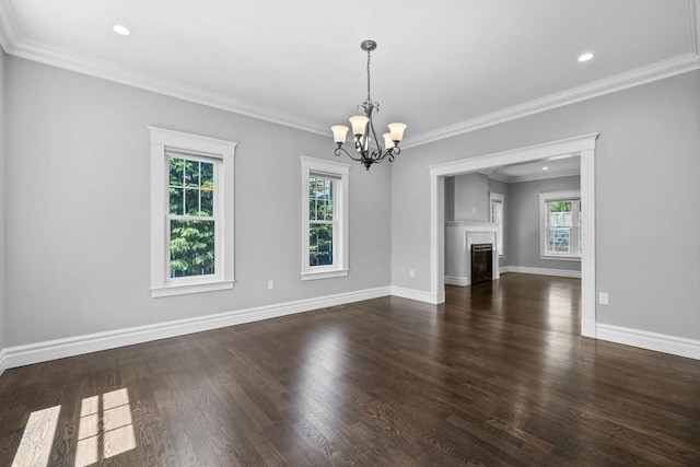 1 Farwell Cir, Newton, MA 02460 - unfurnished living room with plenty of natural light, a chandelier, wood finished floors, baseboards, and crown molding