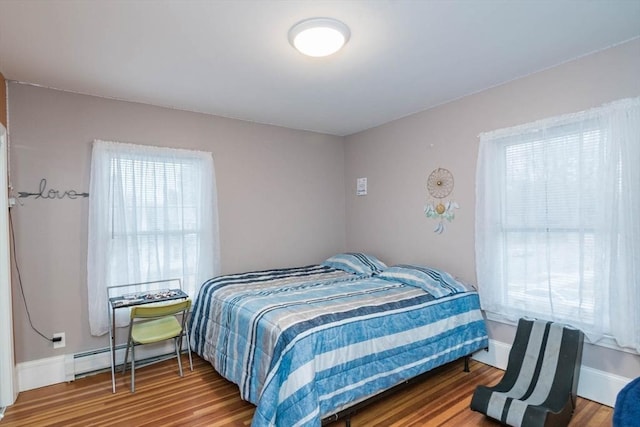 bedroom with hardwood / wood-style flooring and a baseboard radiator