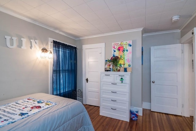 bedroom with dark hardwood / wood-style flooring and ornamental molding