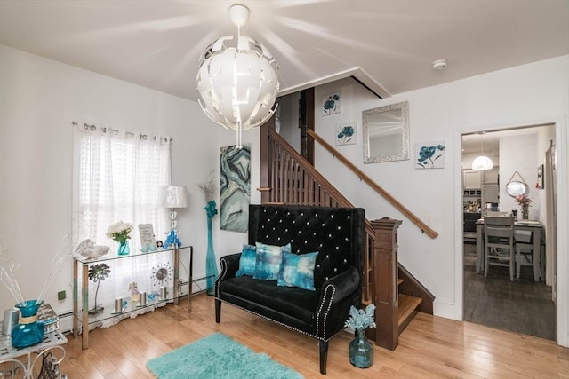 miscellaneous room featuring hardwood / wood-style flooring, baseboard heating, and a notable chandelier