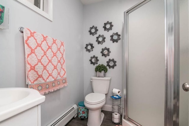 bathroom featuring toilet, a shower with door, and a baseboard radiator