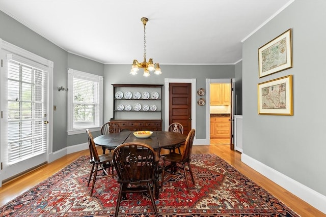 41 Clarke St, Lexington, MA 02421 - dining area featuring a chandelier, light wood finished floors, baseboards, and crown molding
