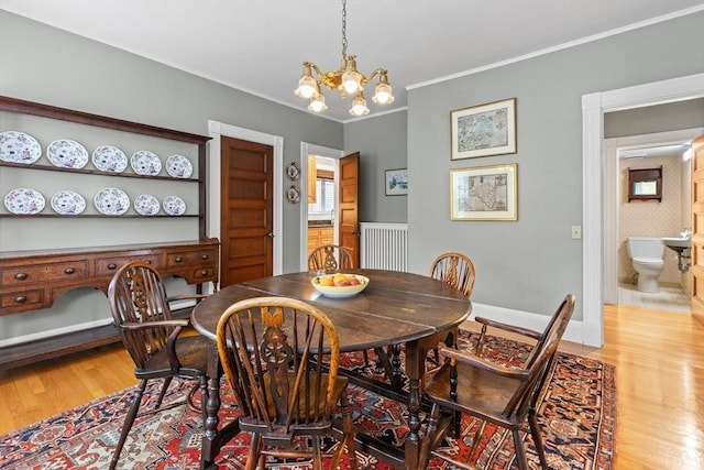 41 Clarke St, Lexington, MA 02421 - dining space featuring light wood finished floors, a chandelier, and crown molding